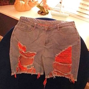 Blue jean ripped shorts with orange strings